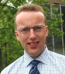 a man wearing glasses and a tie